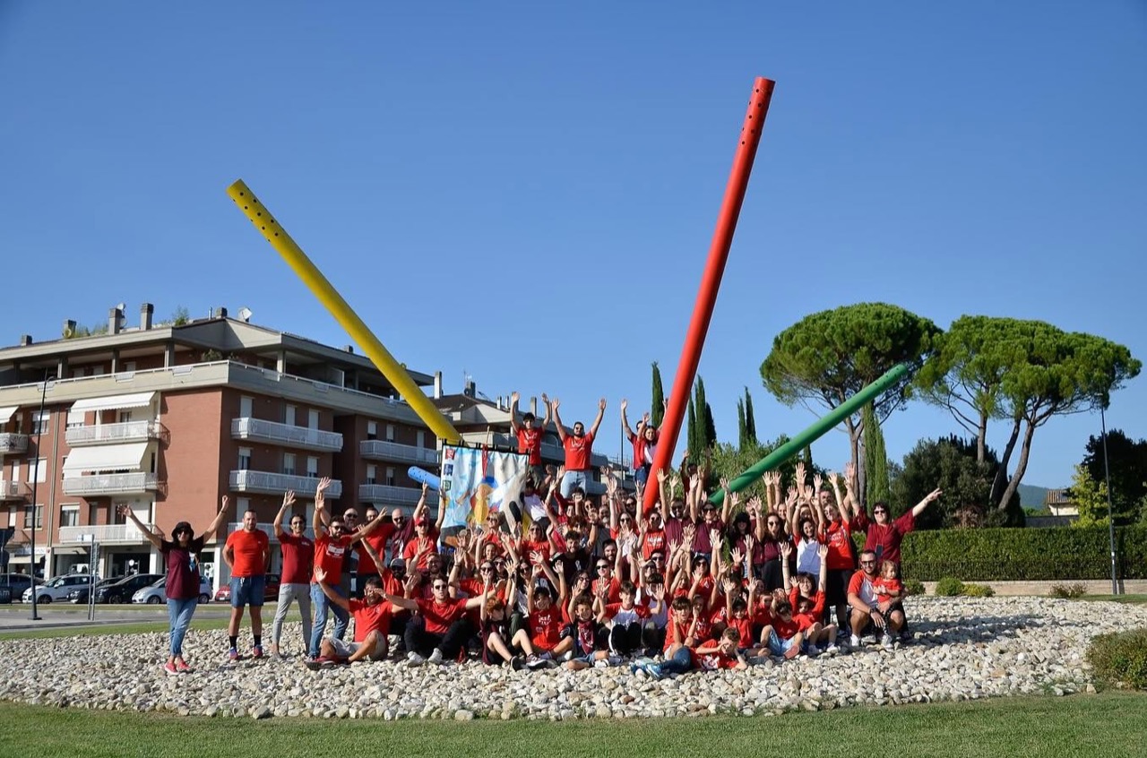 Foto di gruppo dei rionali di Moncioveta in maglia rossa alla rotonda